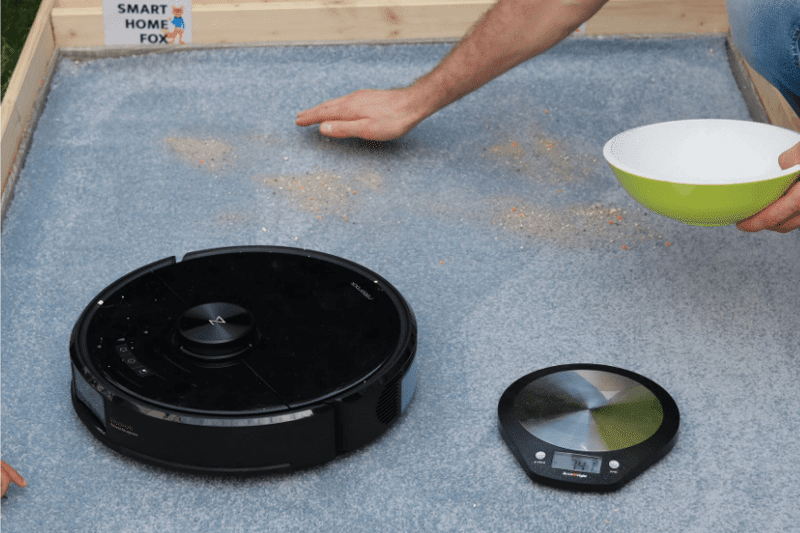 Roborock S6 MaxV during the sand suction test on a carpet.